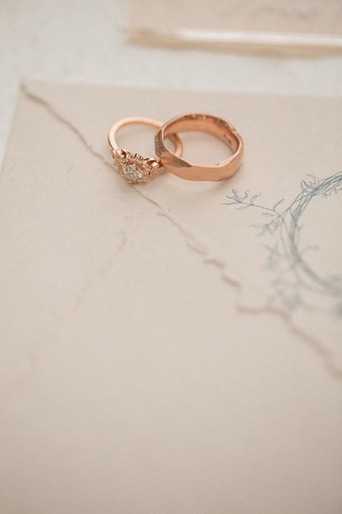 Polished steel band ring on white marble